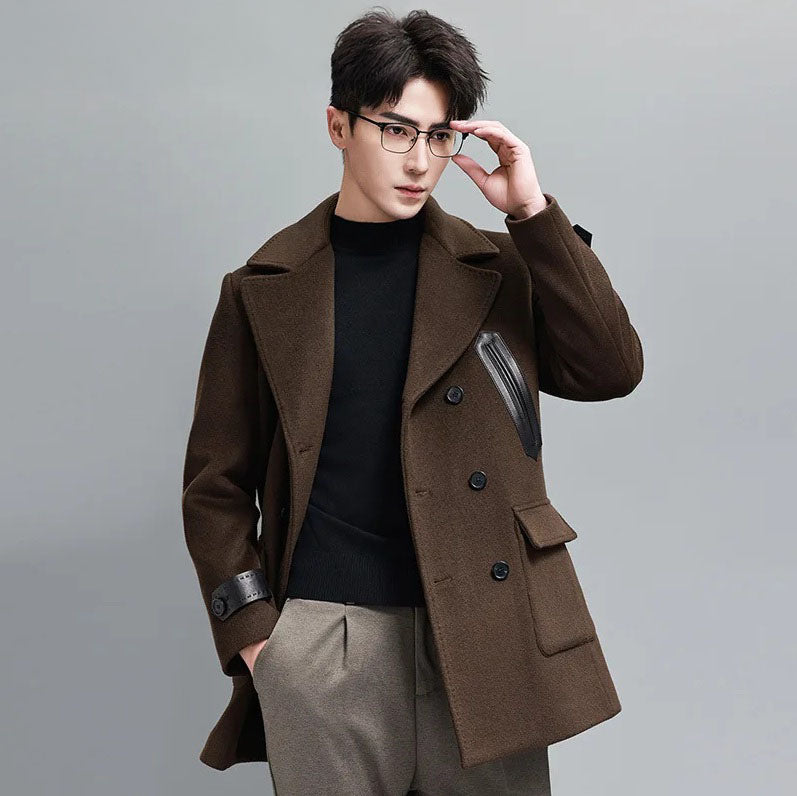 Model in Dark Rum double-breasted wool-cashmere coat with leather accents, adjusting glasses. From Borcelleclothes.