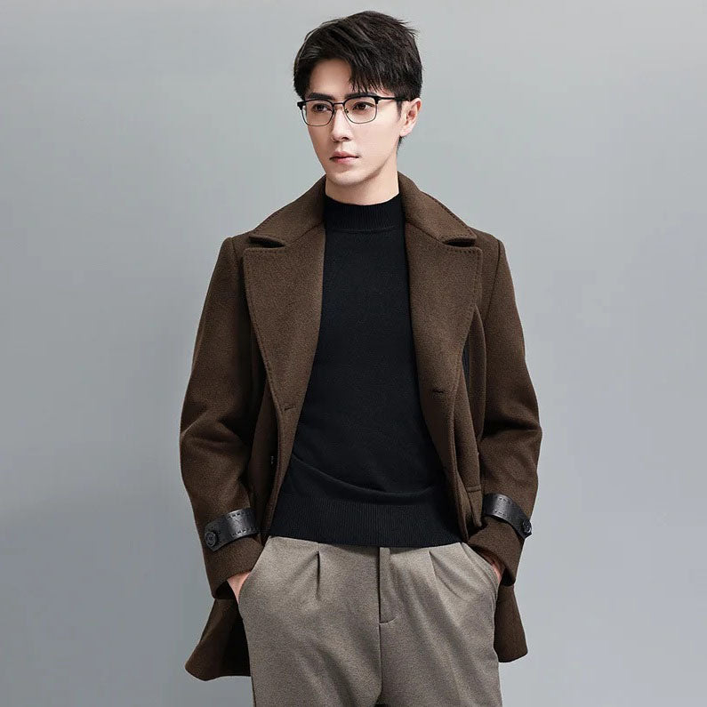 Model wearing Dark Rum double-breasted wool-cashmere coat with hands in pants pockets. From Borcelleclothes.