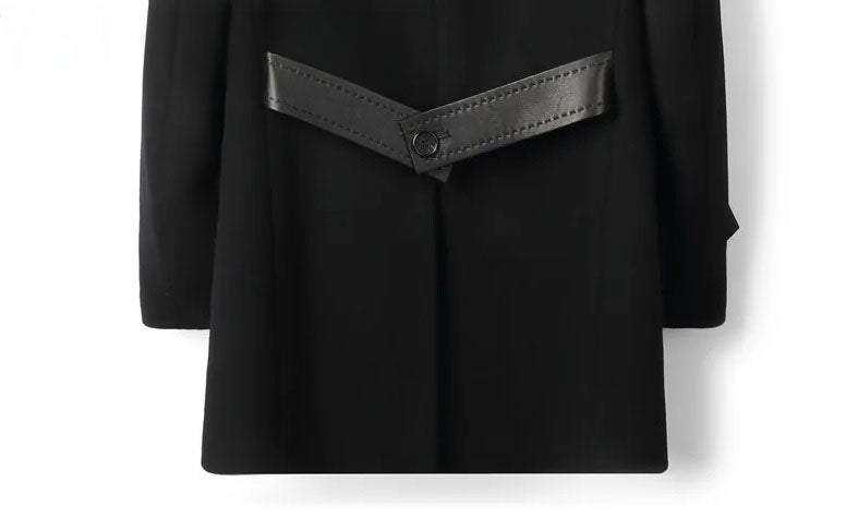 Back lower section of Onyx wool-cashmere coat with decorative leather belts. From Borcelleclothes.