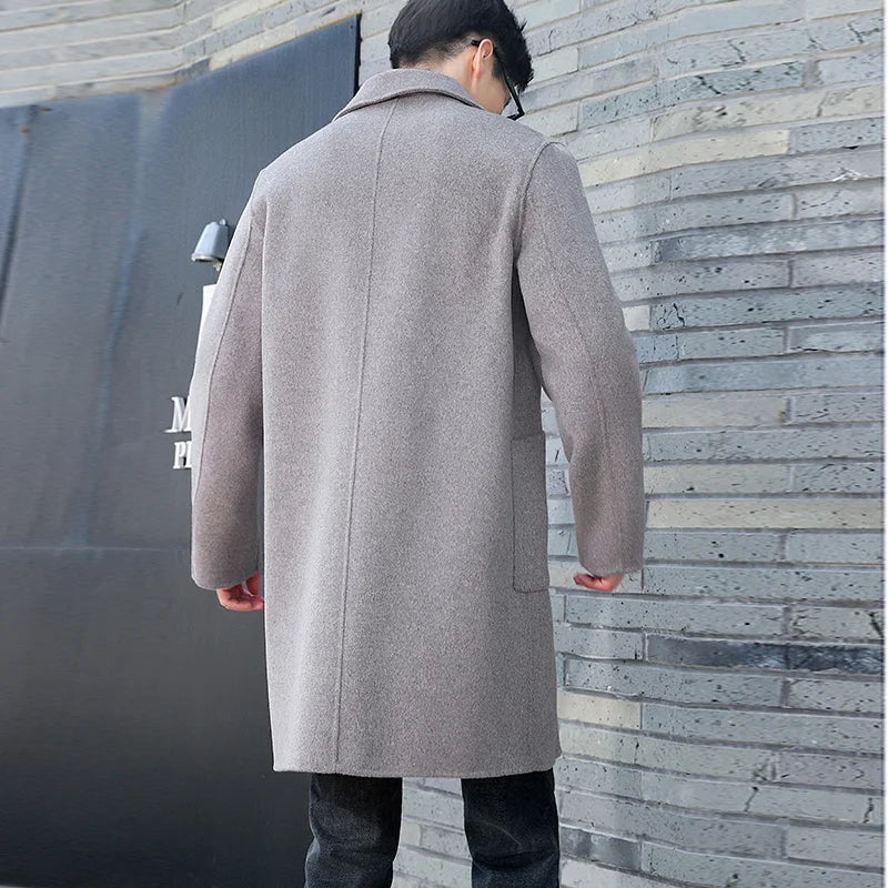Back of the Men’s Double-Sided Wool Coat in Topaz, showcasing its structured silhouette and center vent for ease of movement. From Borcelleclothes.