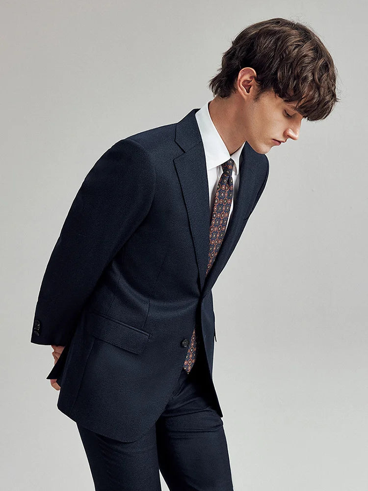 Model slightly bent down in the Borcelleclothes Men's Ebony Clay 3-Piece Suit, emphasizing the flexibility and modern tailoring of the fabric.