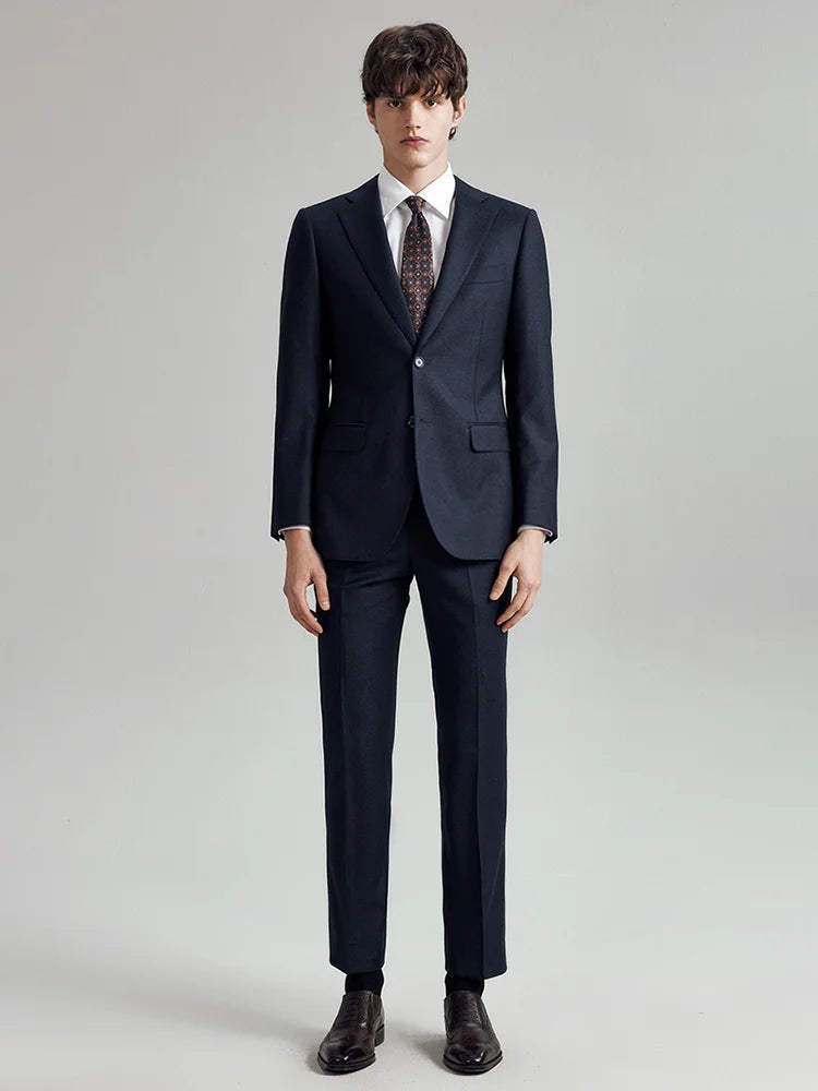 Model standing with straight arms in the Borcelleclothes Men's Ebony Clay 3-Piece Suit, highlighting the sharp, polished silhouette of the blazer and pants.