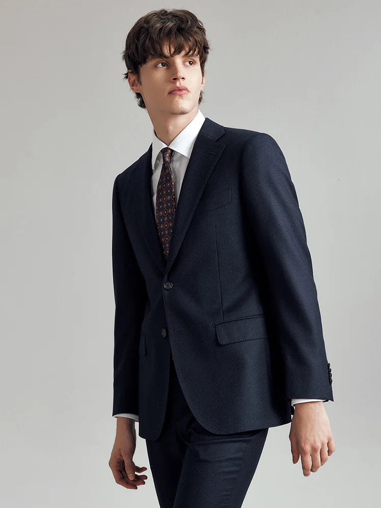 Model in the Borcelleclothes Men's Ebony Clay 3-Piece Suit, turned slightly to the side, showcasing the sleek tailoring and refined pinstripe pattern.