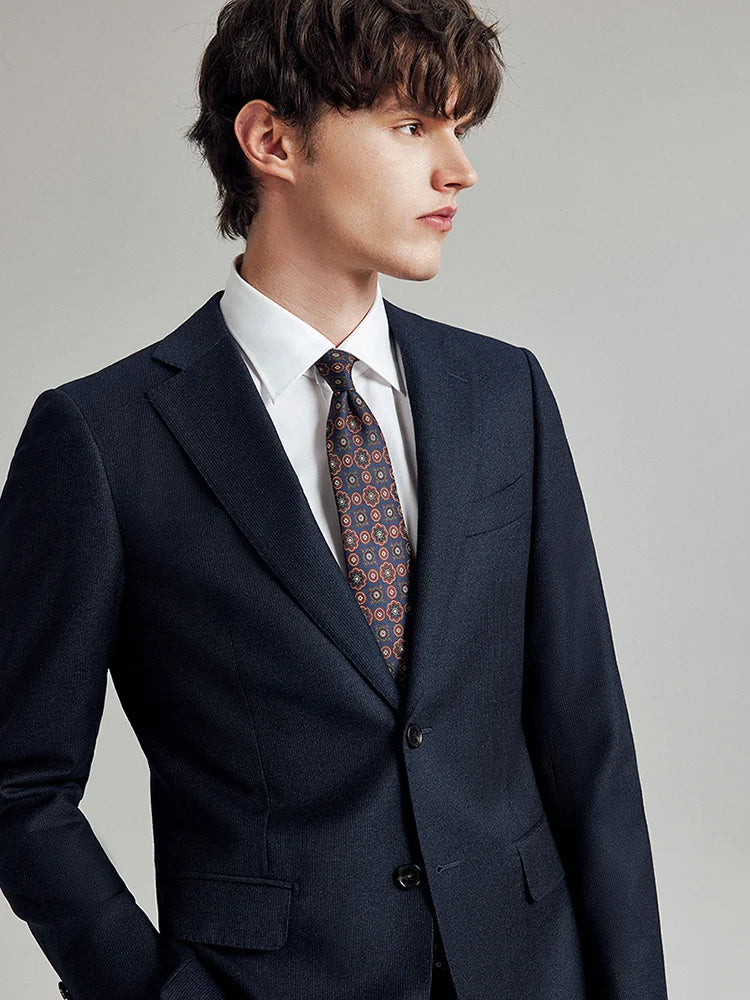 Model in the Borcelleclothes Men's Ebony Clay 3-Piece Suit, gazing to the side, highlighting the refined details of the blazer and vest.