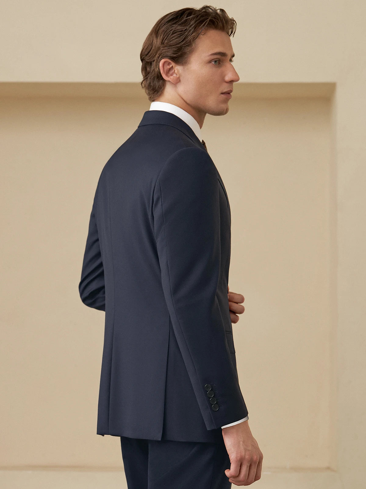 Back of the Borcelleclothes Men's Ebony Clay Business Suit, highlighting the blazer’s double vent and the clean silhouette of the pants.