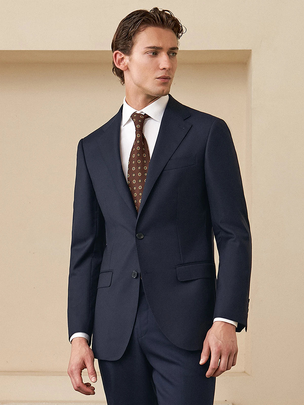 Model wearing the Borcelleclothes Men's Ebony Clay Business Suit, gazing to the side, showcasing the blazer’s sleek tailoring and the muted, professional Ebony Clay tone.
