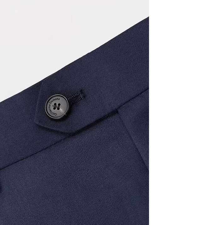 The secure button closure on the pants of the Borcelleclothes Men's Ebony Clay Suit with Bold Brass Accents, emphasizing functionality and elegance.