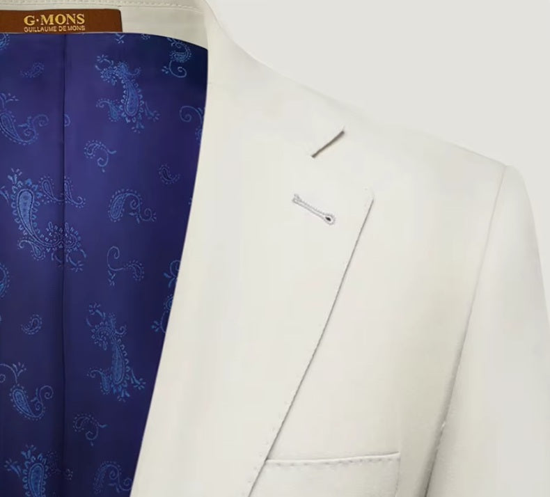 The contrast purple paisley lining under the lapel of the Borcelleclothes Men's Ecru White Suit blazer, showcasing the unique design detail.