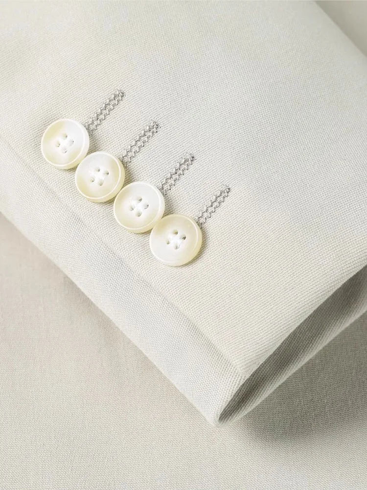 The sleeve placket on the Borcelleclothes Men's Ecru White Suit blazer, featuring four decorative buttons for a sophisticated touch.