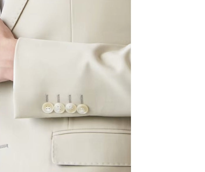 Close-up of the model wearing the Borcelleclothes Men's Ecru White Suit, focusing on the sleeve placket and its decorative button details.