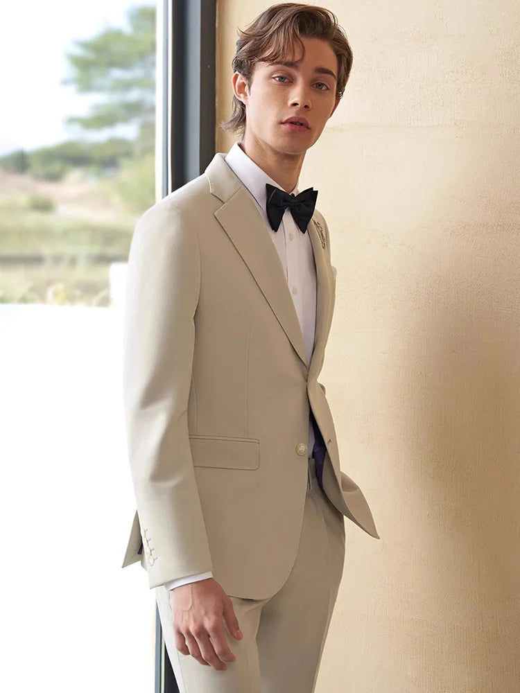 Model wearing the Borcelleclothes Men's Ecru White Suit, turned slightly to the side, showcasing the tailored blazer and elegant ecru white color.