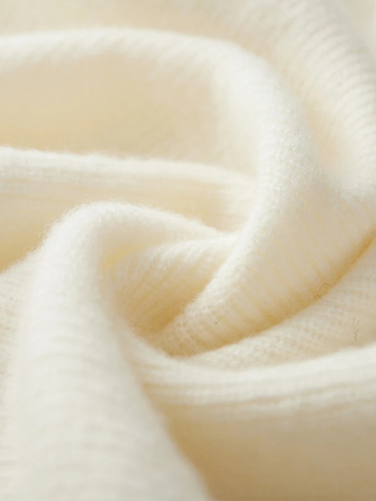 Spiral-folded display of Alabaster fisherman rib cashmere sweater, showing ribbed texture and airy thickness — From Borcelleclothes.