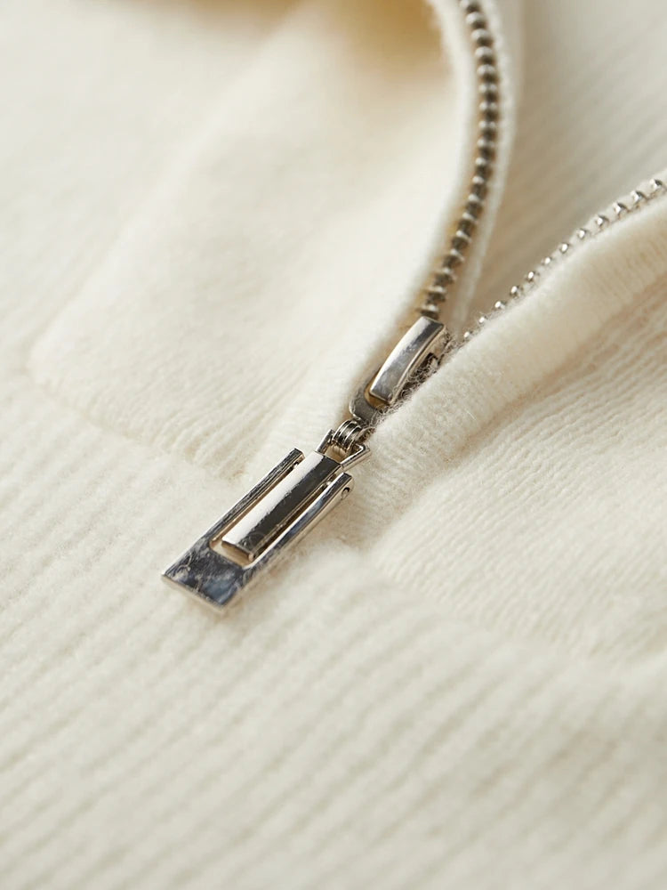 Close-up of concealed zipper puller at trapeze neckline on Alabaster fisherman rib cashmere sweater — From Borcelleclothes.