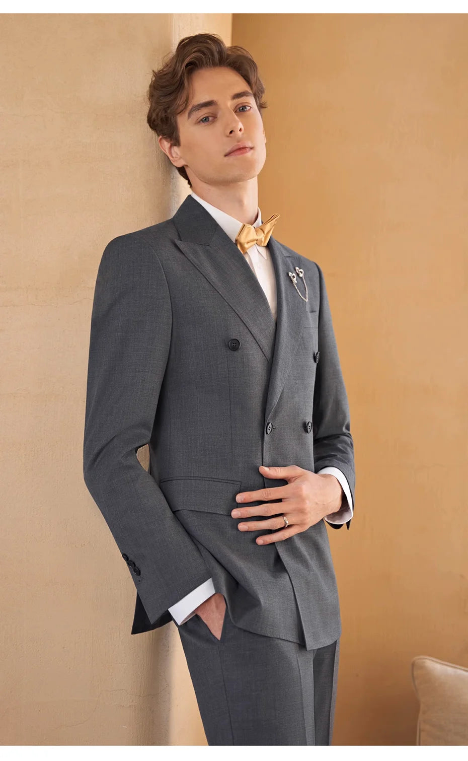 Model wearing Davy Grey suit with hand resting on stomach — composed posture, quiet authority. From Borcelleclothes.