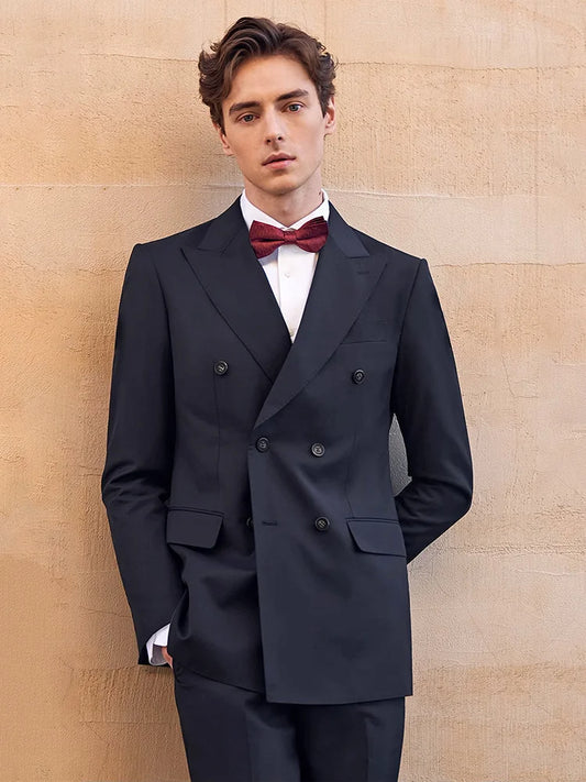 Men’s formal double-breasted wool suit in Ebony Clay with peaked lapels and four-button sleeve plackets — structured, composed, and quietly commanding. From Borcelleclothes.
