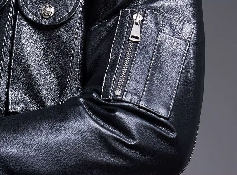 Detail of zippered pocket on left sleeve with additional small compartment above, highlighting asymmetry. From Borcelleclothes.