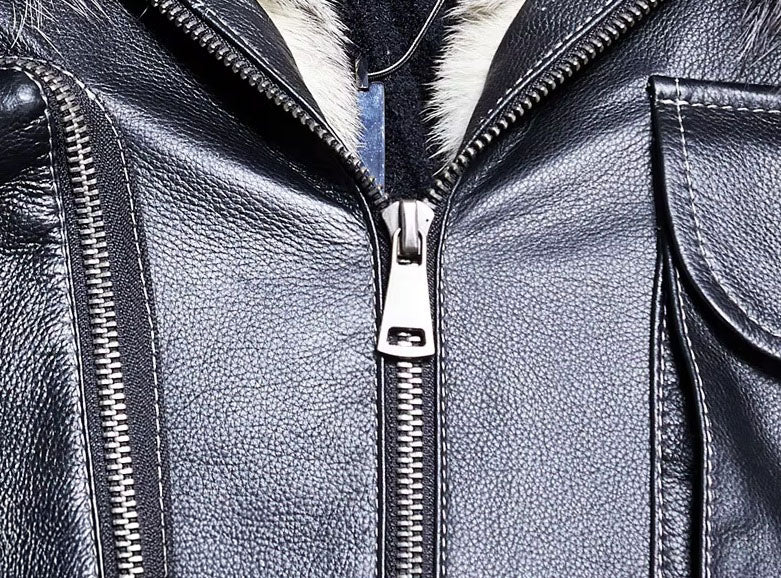 Close-up of exposed metal zipper puller on Onyx cowhide jacket, showing functional hardware detail. From Borcelleclothes.