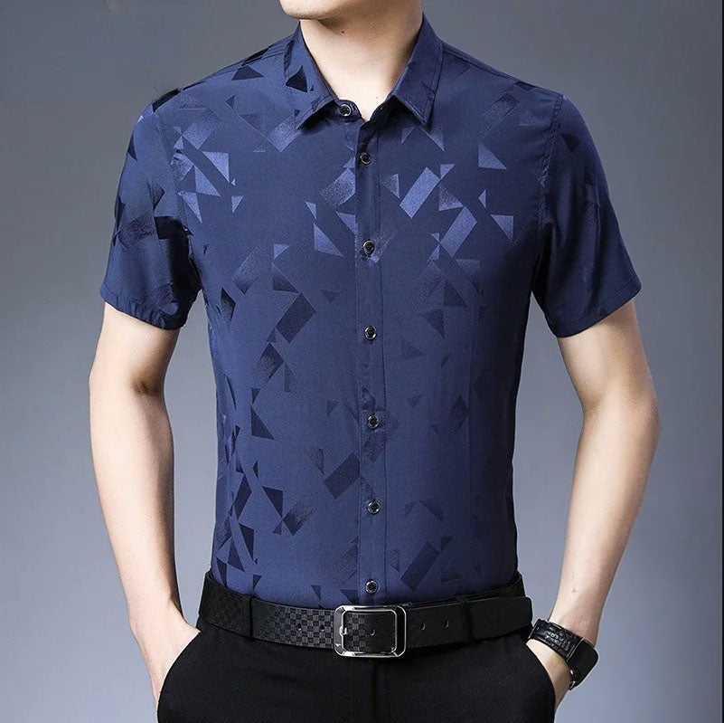 Men's Mulberry Silk Shirt from the Geometric Collection in Dusky Blue, featuring vibrant geometric designs with sharp shapes that burst like fireworks, creating a dynamic motion and soft dispersion effects, enhanced by the silk's natural sheen. From Borcelleclothes.