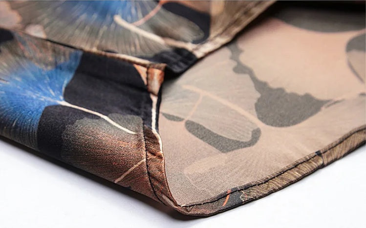 Lower part of the Ginkgo silk shirt with natural hemline and continuous leaf design over black silk. From Borcelleclothes.