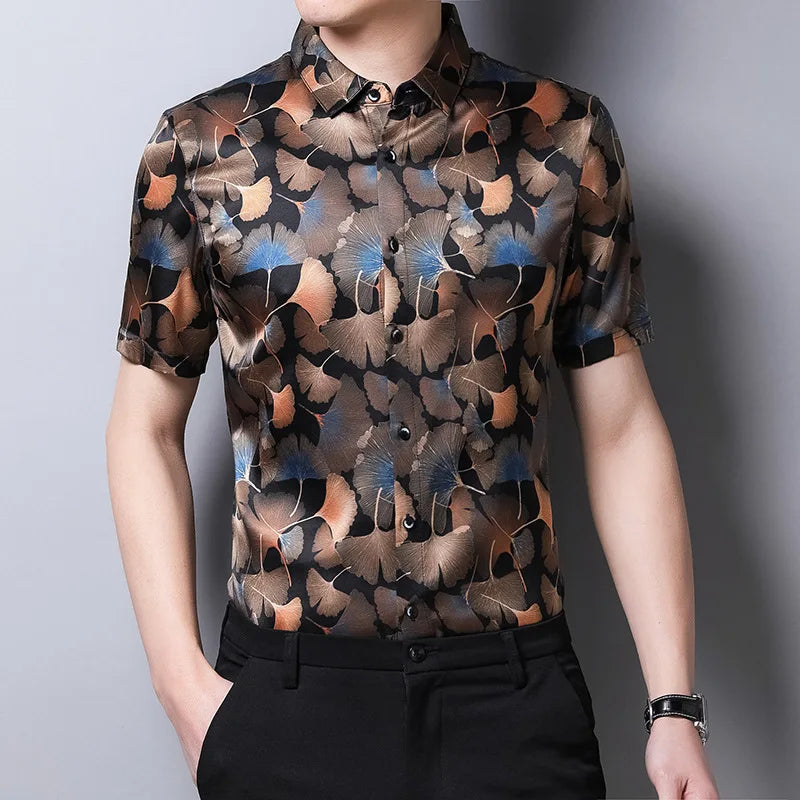 Model wearing the men’s Ginkgo silk shirt, hand in pants pocket, showing the warm-toned leaf pattern on black silk. From Borcelleclothes.