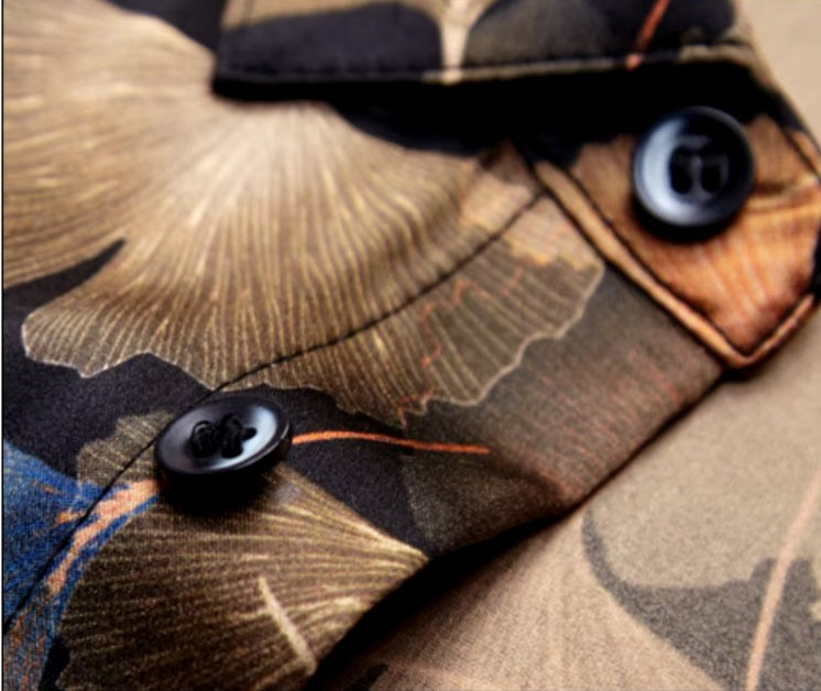 Front placket of the Ginkgo silk shirt with visible stitching and overlapping leaves in amber and blue hues. From Borcelleclothes.