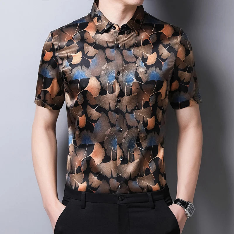 Men’s short-sleeved Ginkgo silk shirt in black with a pattern of warm-toned ginkgo leaves and blue accents. From Borcelleclothes.