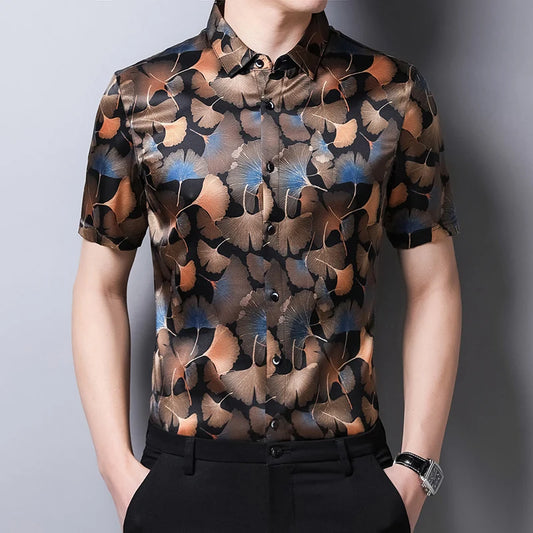 Men’s short-sleeved Ginkgo silk shirt in black with a pattern of warm-toned ginkgo leaves and blue accents. From Borcelleclothes.