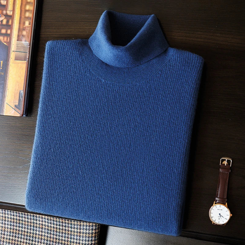 Folded Men's Grade A Alashan Cashmere Turtleneck Sweater in Regal Blue, styled with a watch and phone to emphasize its refined elegance and versatility. From Borcelleclothes.