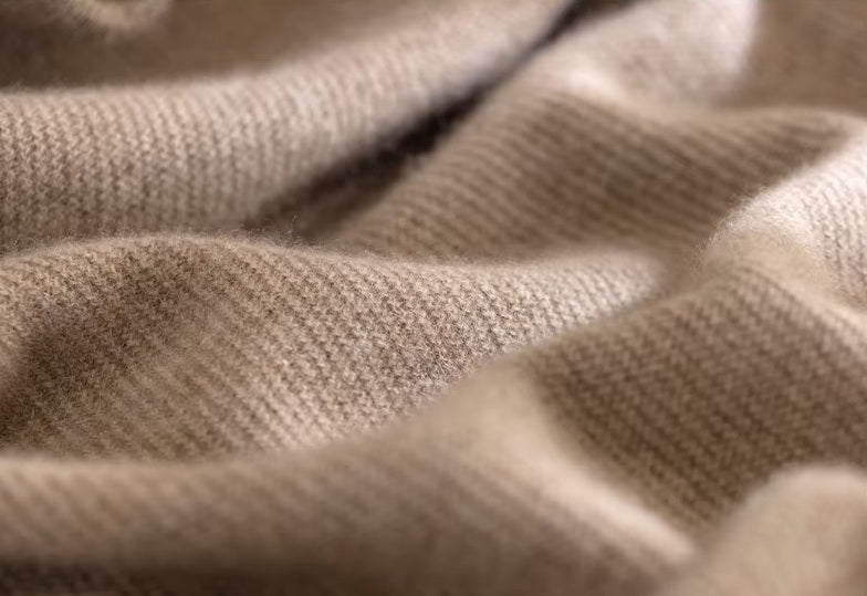 Men's Grade A Alashan Cashmere Turtleneck Sweater in Sandal being held, showcasing its lightweight and ultra-soft cashmere fabric. From Borcelleclothes.