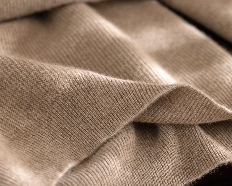 The ribbed bottom hem on the Men's Grade A Alashan Cashmere Turtleneck Sweater in Sandal, providing a structured and polished finish. From Borcelleclothes.