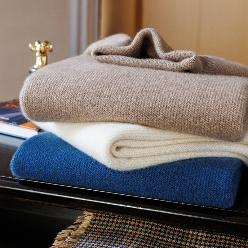 Stacked Men's Grade A Alashan Cashmere Turtleneck Sweaters in Sandal, Pearl Bush, and Regal Blue, showcasing their elegant shades and intricate textures. From Borcelleclothes.