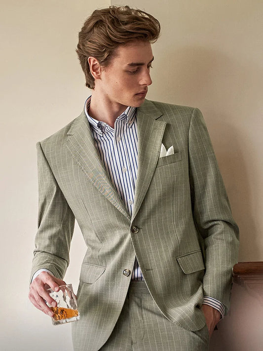 Men’s grey olive pinstripe suit featuring a tailored blazer with notch lapels and horn buttons, straight-leg trousers with adjustable waistband, and optional matching vest. From Borcelleclothes.