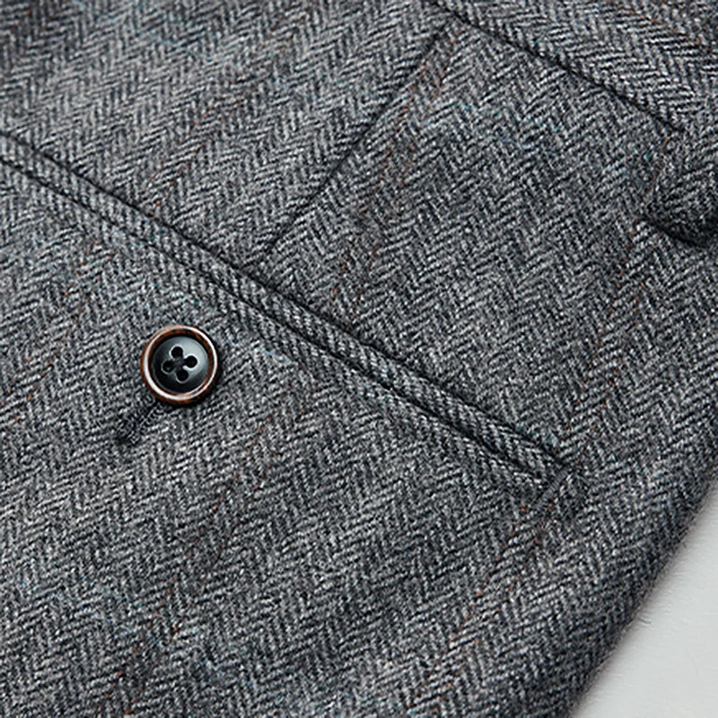 Back view of herringbone wool trousers showing double-welt pocket with button detail. From Borcelleclothes.