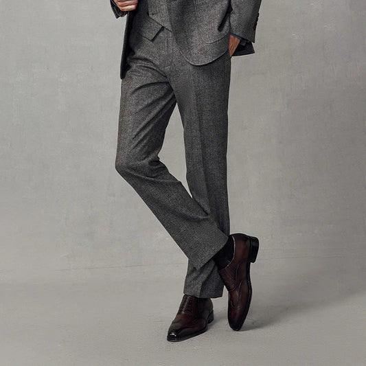 Men's slim herringbone wool trousers in Cloudy Grey with subtle brownish pinstripes, featuring adjustable waistband, side slash pockets, and double-welt back pockets with buttons. From Borcelleclothes.