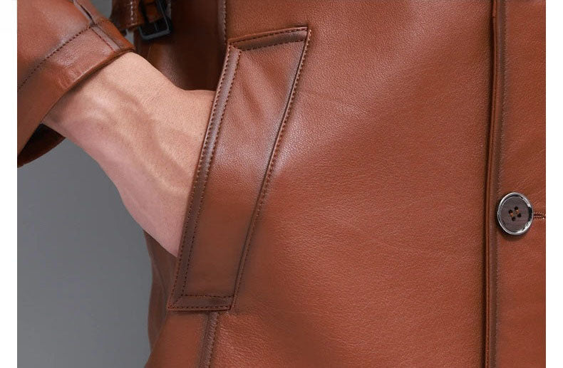 Men’s hooded cowhide leather jacket in Nutmeg — close-up of pocket section with model’s hand. From Borcelleclothes.