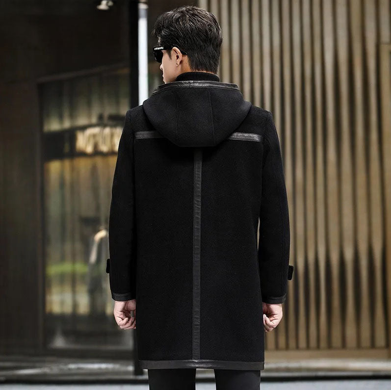 Back view of an onyx hybrid wool-leather coat, showing leather trim details. From Borcelleclothes.