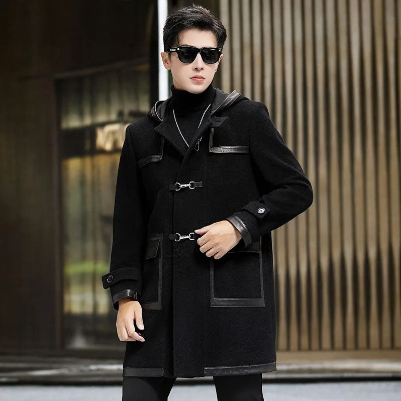 Close-up of model adjusting a swivel clasp on an onyx hybrid wool-leather coat. From Borcelleclothes.