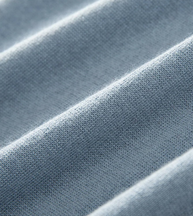 Close view of the Echo Blue silk-cashmere polo — showing the natural wave-like texture created by the fabric’s delicate drape. From Borcelleclothes.