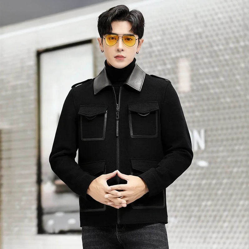Onyx men’s leather-accented mini-coat, model with crossed fingers, highlighting structured mini-coat silhouette and leather accents. From Borcelleclothes.