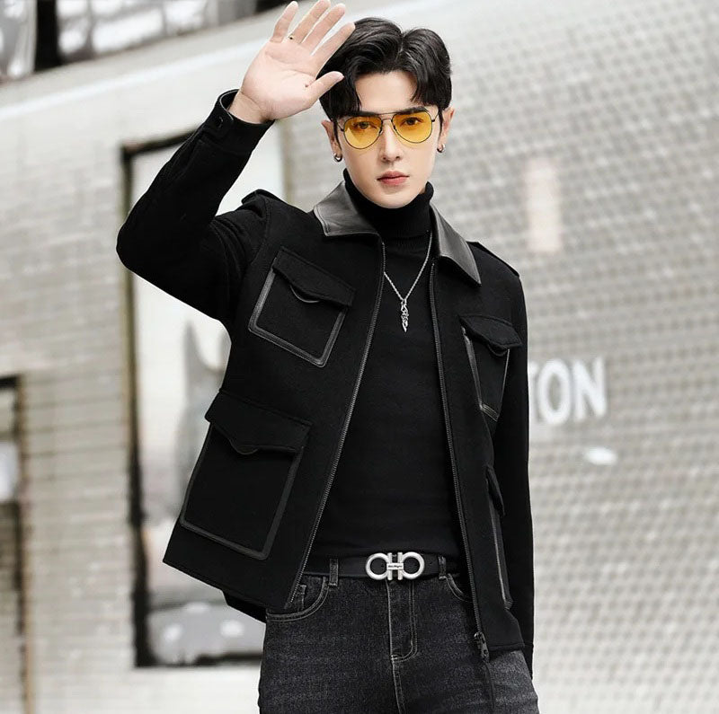 Onyx men’s leather-accented mini-coat, model waving hand, featuring genuine leather collar and tailored lines. From Borcelleclothes.