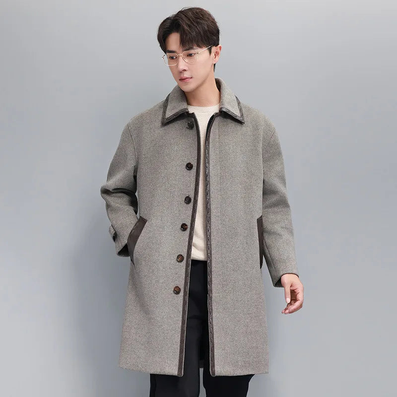 Men’s wool-cashmere coat with leather cord weaving in Mountain Mist, pointed collar, concealed placket, raglan sleeves, and leather-trimmed pockets. From Borcelleclothes.