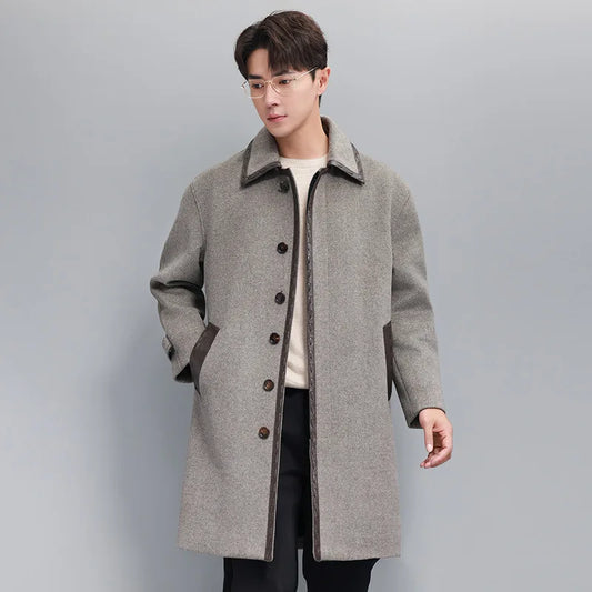 Men’s wool-cashmere coat with leather cord weaving in Mountain Mist, pointed collar, concealed placket, raglan sleeves, and leather-trimmed pockets. From Borcelleclothes.