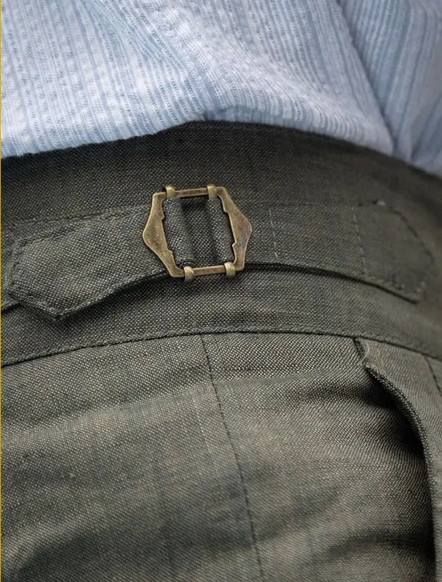 Close-up of the side adjuster detail on sage green linen tailored shorts. From Borcelleclothes.