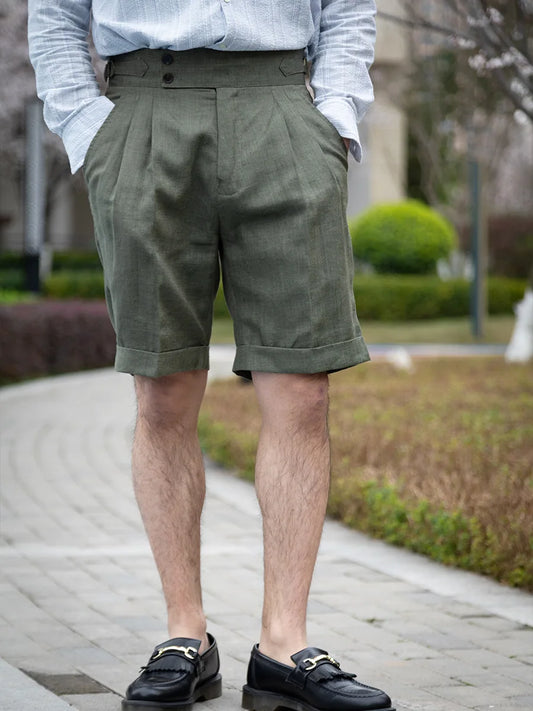Men’s tailored linen shorts in Sage, featuring front tucks and neatly turned-back cuffs. From Borcelleclothes.