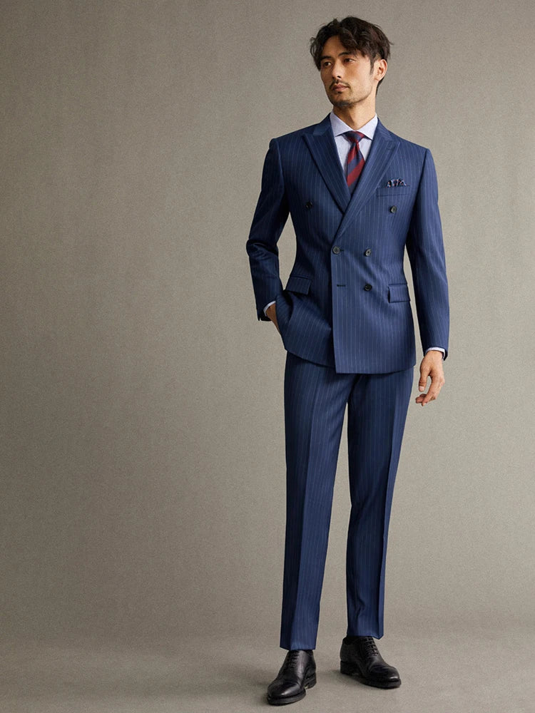 Model wearing the Borcelleclothes Men's Lucky Point Pinstripe Suit, with one hand in the pant pocket, highlighting the sleek tailoring and pinstripe pattern.