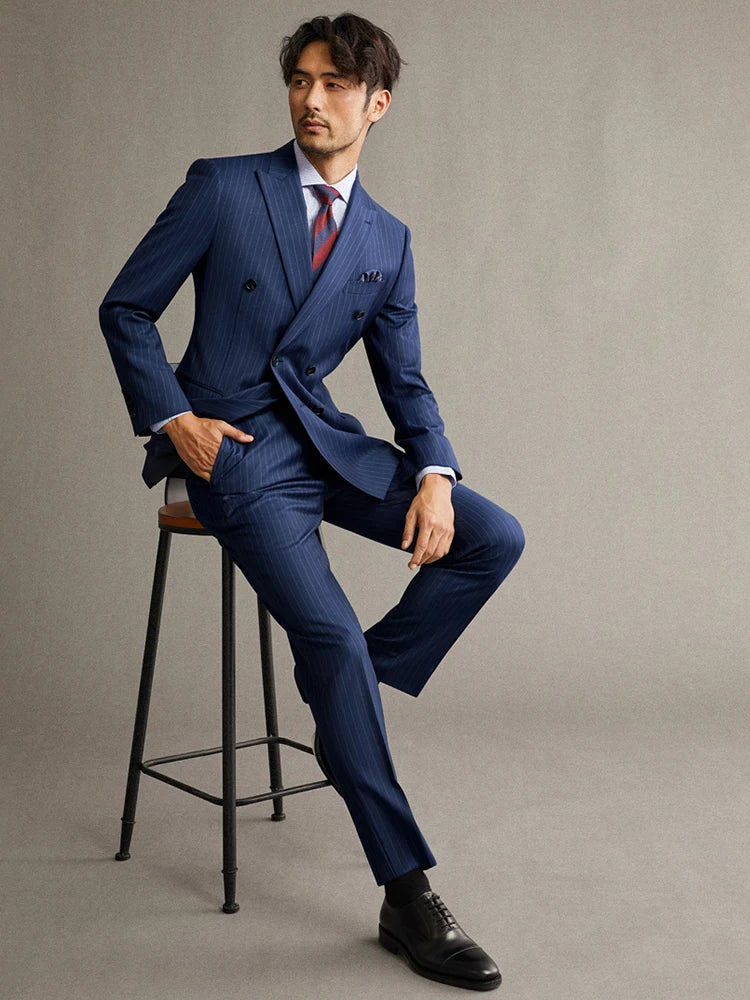 Model seated in a chair, dressed in the Borcelleclothes Men's Lucky Point Pinstripe Suit, showcasing the elegant and versatile design of the blazer and pant.