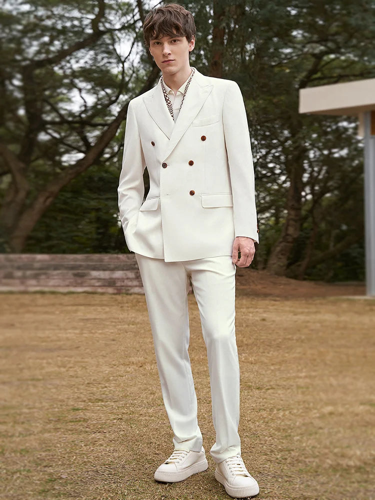 Model wearing the Men's Luxury Alabaster Suit with one foot forward, emphasizing the suit's fit and movement. From Borcelleclothes.