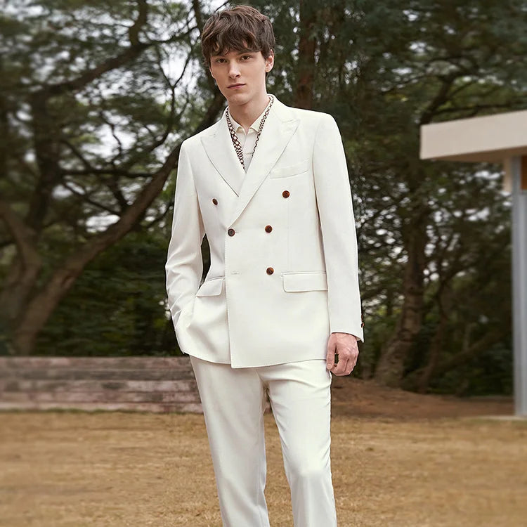 Model wearing the Men's Luxury Alabaster Suit with one hand casually placed in the pants pocket, showcasing its tailored fit. From Borcelleclothe.