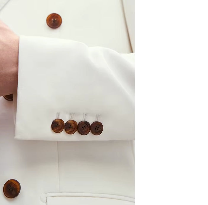 The Men's Luxury Alabaster Suit's sleeve placket with four horn-brown buttons, highlighting craftsmanship. From Borcelleclothes.