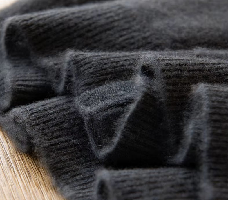 The ribbed bottom hem on the Men's Luxury Albas Cashmere Cardigan in Dune, emphasizing its structured and elegant design. From Borcelleclothes.